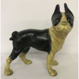 A painted cast iron figurine of a French Bulldog, in black and cream.