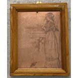 A framed copper printing plate of an Edwardian lady stood reading by a fireplace.