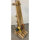 A wooden 4 player croquet set by Bex complete with wheeled trolley.