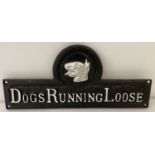 A painted cast metal wall plaque; Dogs Running Loose.