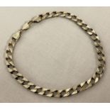 A silver curb chain bracelet with lobster clasp, marked 925 to clasp and fixings.