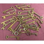 28 vintage metal keys in varying sizes.