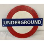A London Underground painted cast metal wall plaque with fixing holes.