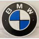 A circular shaped BMW painted cast iron wall plaque with fixing holes.