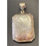 A vintage silver square shaped locket with engraved decoration to front, back and bale.