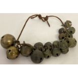 A collection of 16 metal detector find crotal/rumble cow bells. Together with 2 brass cow bells.