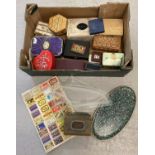 A box of vintage and modern tins and trinket boxes.