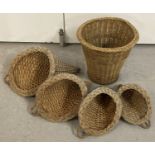 A set of 4 graduating size wicker cornucopia baskets together with a vintage cane waste paper basket