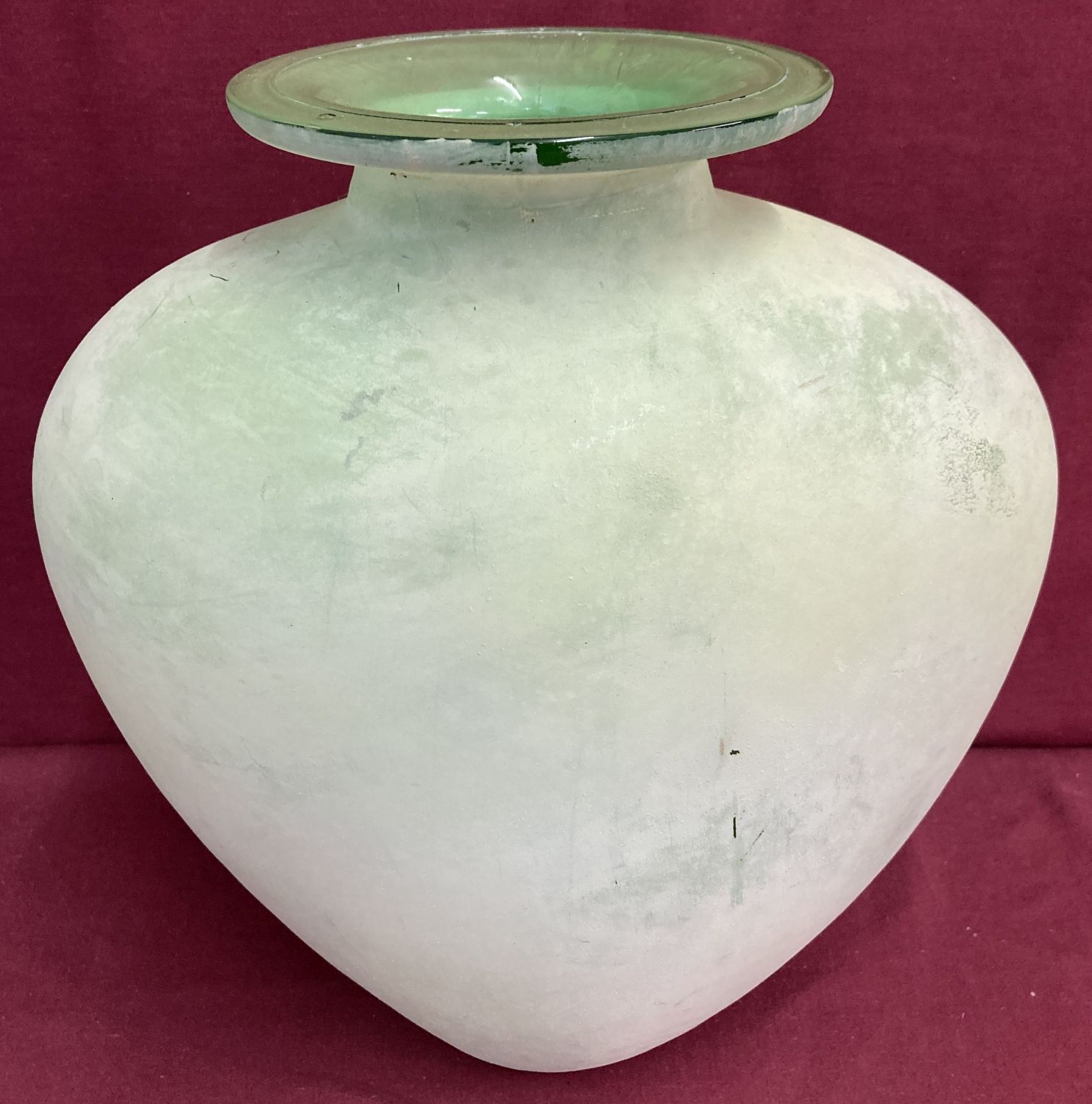 A large bulbous form green art glass vase.