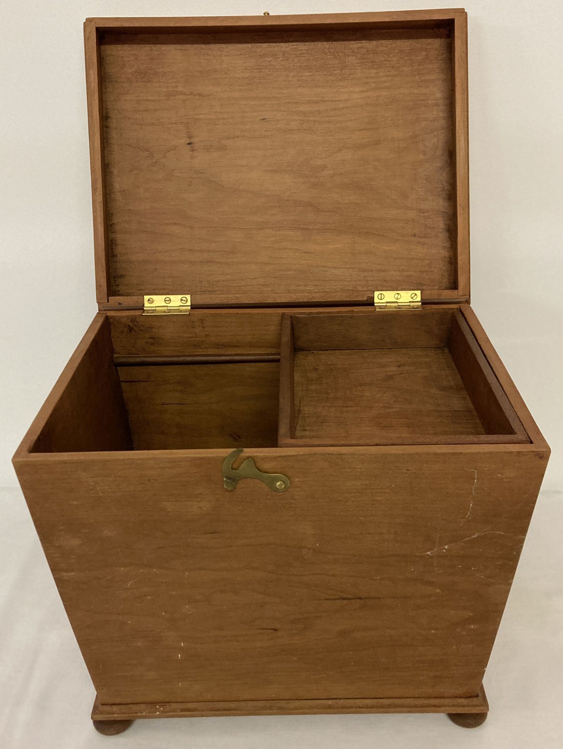 A vintage slope sided wooden box raised on 4 bun feet with sliding tray to interior.
