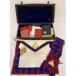 A vintage Masonic cowhide case containing a quantity of Royal Arch Companions Regalia and books.