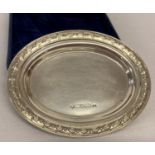 A boxed sterling silver oval shaped pin dish with floral detail to rim.