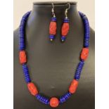 A 19" Lapis Lazuli and red cinnabar beaded necklace and matching earrings.
