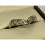 A 9ct gold wishbone dress ring set with Swiss blue topaz and diamonds.