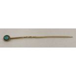 A vintage 9ct gold stick pin set with a round turquoise cabochon.