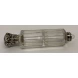 A vintage glass and white metal double ended perfume bottle. One lid missing.