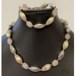 A matching silver and rose quartz necklace and bracelet.