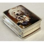 A small white metal pill box marked "Sterling" with ceramic plaque to lid.