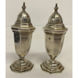 A boxed pair of Edwardian silver pepperettes, hallmarked Chester 1907.