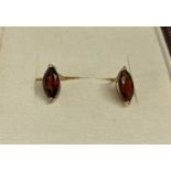 A pair of 9ct gold stud style earrings set with marquise cut garnets.