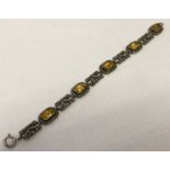 A vintage silver citrine and marcasite set bracelet with openwork panels.