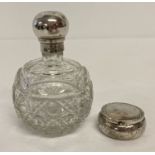 A silver oval shaped pill box with engraved decoration to top and body with empty cartouche.