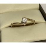 A 9ct gold twist design .15ct diamond solitaire ring.