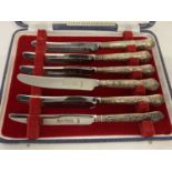 A boxed set of King's Pattern silver handled butter knives.