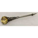 A vintage white metal twist stem brooch set with a large citrine and marcasite stones.