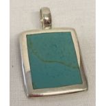 A modern design silver and turquoise square pendant. Silver marks to back of pendant and bale.
