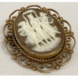 A vintage cameo brooch depicting the 3 muses in a decorative 9ct gold surround with pendant bale.
