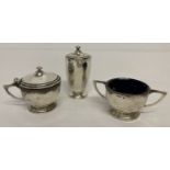 An Art Deco design hallmarked silver 3 piece cruet set with blue glass liners.