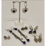 5 pairs of silver and white metal earrings in both drop and stud styles.