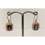 A pair of 9ct gold amethyst and seed pearl earrings in a drop style.