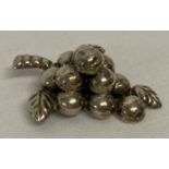 A Mexican silver brooch in the shape of a bunch of grapes.