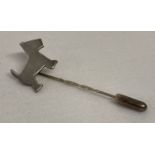 A silver Highland Terrier dog stick pin.