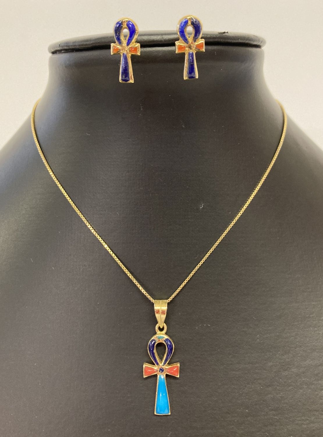 An Egyptian 18ct gold Ankh shaped pendant with matching earrings, set with natural stones.