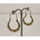 A pair of 9ct gold creole style hoop earrings. Posts marked 9ct.