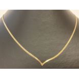 A 9ct gold flat herringbone style wishbone necklace.