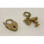 A gold pendant/charm in the shape of a stork carrying a baby. Together with a gold padlock.