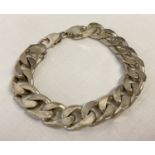 A heavy silver curb chain bracelet with lobster clasp.