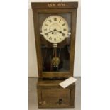 A vintage oak cased Gledhill-Brook Time Recorders Ltd clocking in machine.