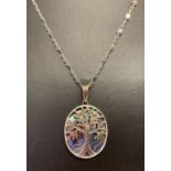 A silver and Paua shell oval "Tree Of Life" pendant on a decorative silver chain.