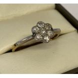 A vintage gold and diamond ladies dress ring in the shape of a flower head.