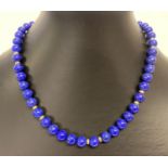 A lapis lazuli bead necklace with 18ct gold clasp by Cellini. Complete with original necklace box.