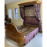 A Victorian Walnut half tester King size bed with curved footboard and canopy.
