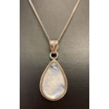 A silver teardrop shaped moonstone pendant on a 16 inch silver curb chain.