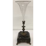 An etched clear glass Victorian trumpet vase in decorative spelter stem mounted on a marble base.