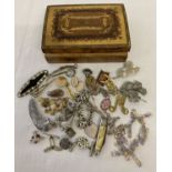 A small wooden trinket box with marquetry decoration containing a small amount of costume jewellery.