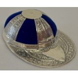 A sterling silver pin cushion in the shape of a jockey's hat, with blue velvet cushion.
